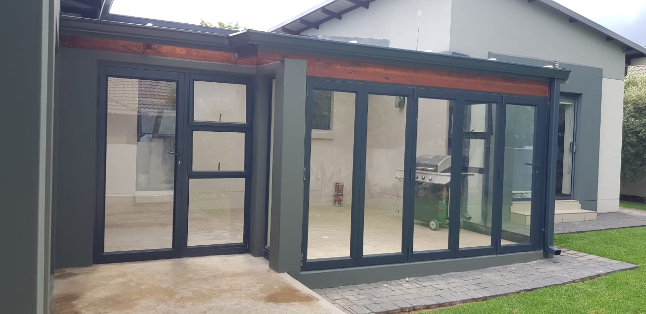 Completed patio enclosure with black aluminium doors